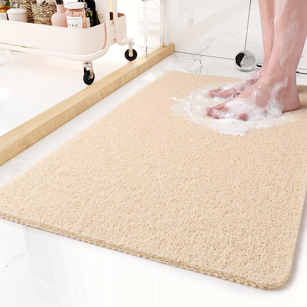 Beige non-slip shower mat with textured surface and low-profile border