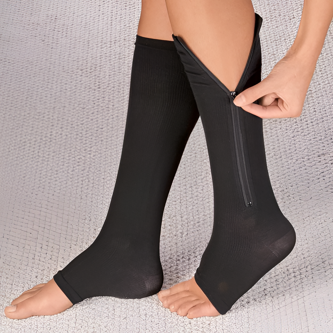 Black compression support socks with side zipper seam, worn on both feet