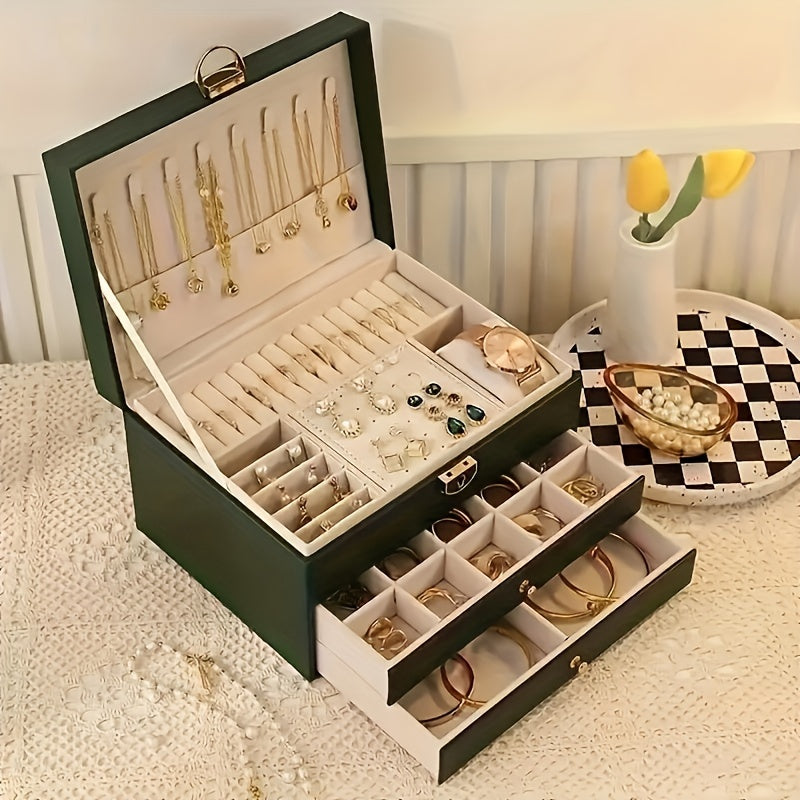 Green multi-layer jewelry storage box with open lid, ring tray, and necklace display.