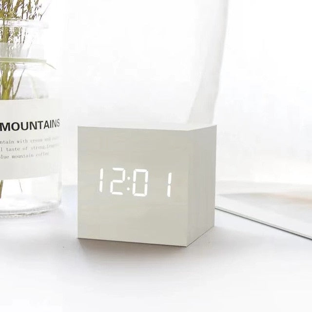 Wooden cube LED alarm clock, white cube showing '12:01' digital time