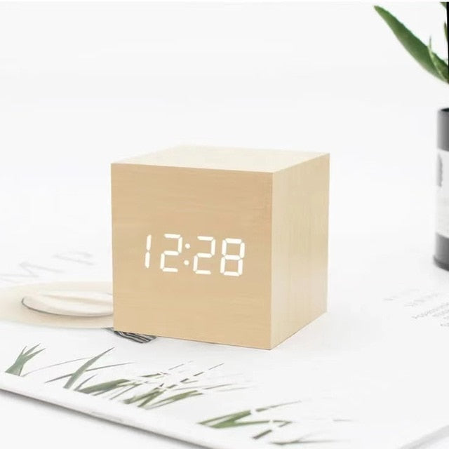 Wooden cube LED alarm clock, beige cube showing '12:28' LED digital time