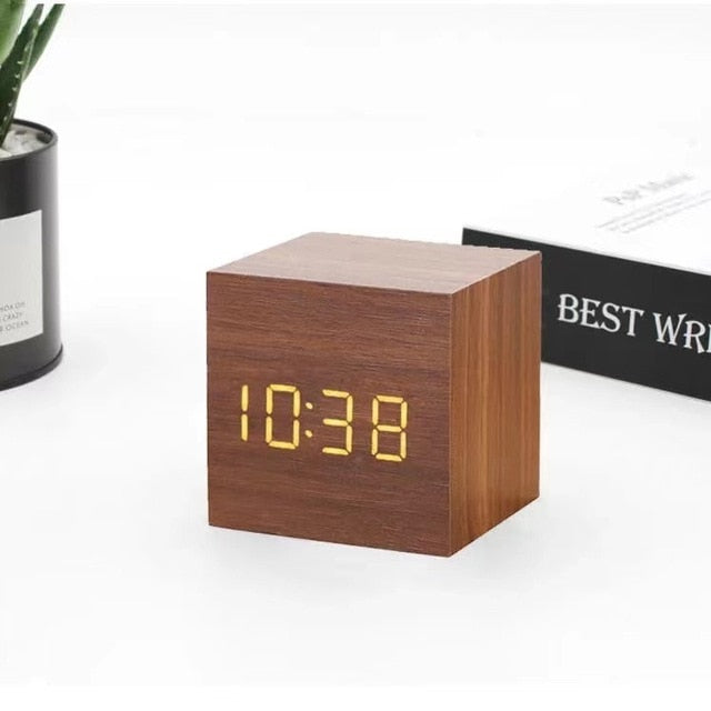 Wooden cube LED alarm clock, brown cube showing '10:38' LED digital time