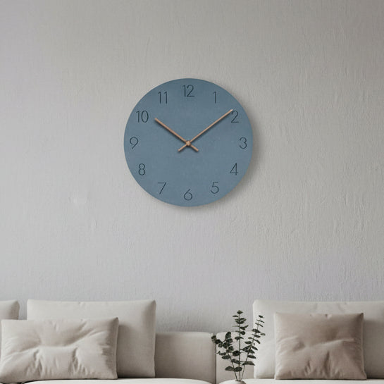 Blue round silent wall clock with black numerals and thin wood hands