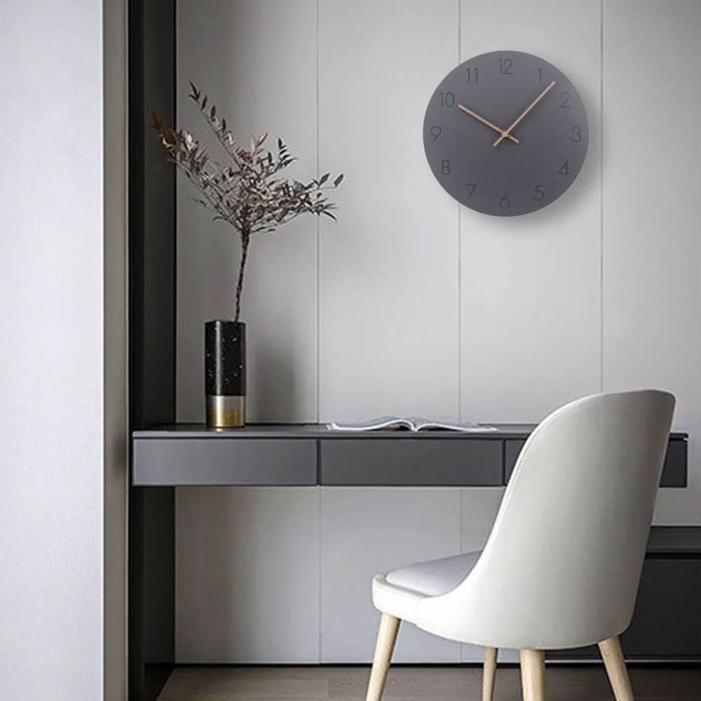 Modern interior with a desk, chair, and decorative clock on a wall.