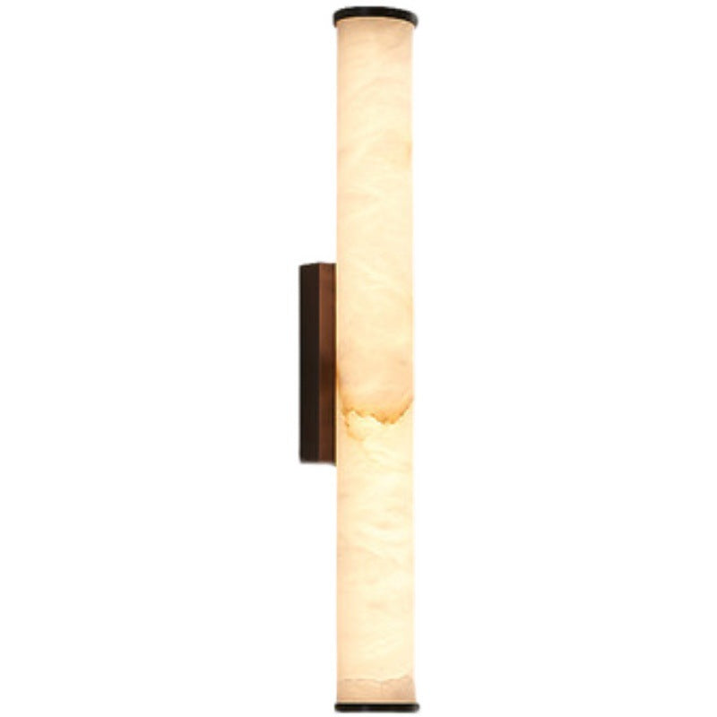 Wall sconce with tall frosted marble-look cylinder and dark metal backplate