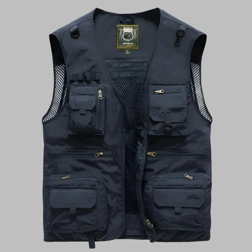 Dark blue multi-pocket travel vest with front zipper, mesh panel, and flap utility pockets