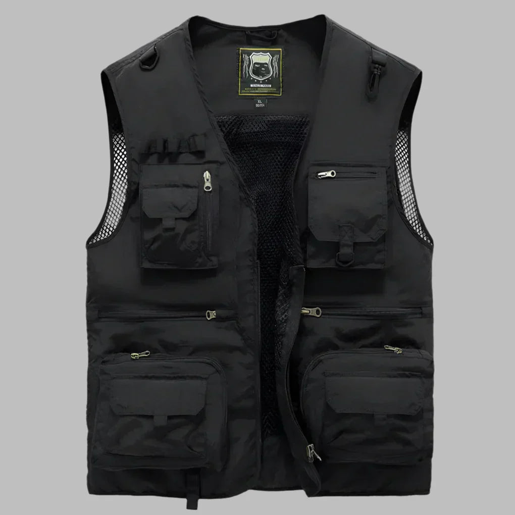 Black multi-pocket travel vest with front zipper, mesh panel, and flap utility pockets