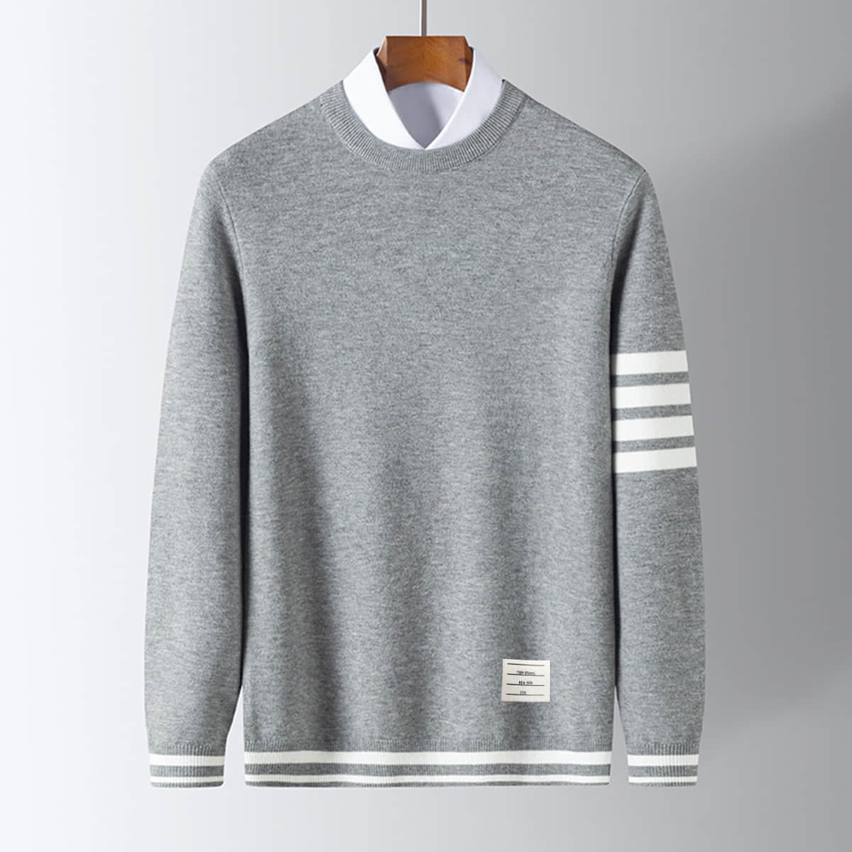 Men's pullover sweater, gray knit with white striped sleeve cuffs and hem band.