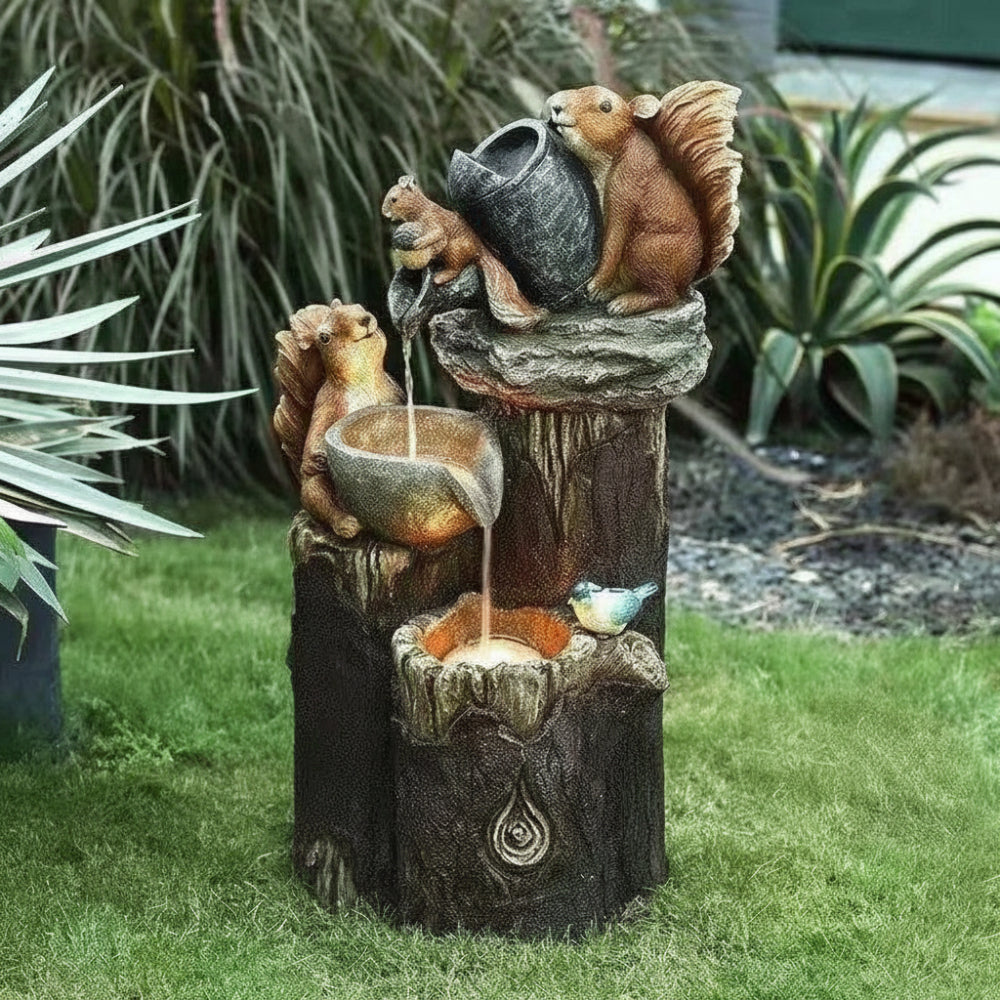 Solar birdbath fountain with squirrel statues and small basin on dark rock base