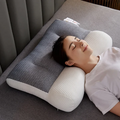 Orthopedic contour neck pillow with gray textured cover and white contoured base