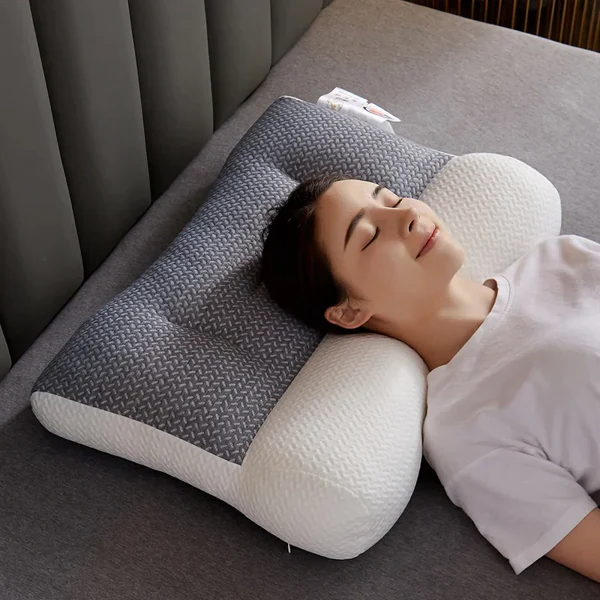Orthopedic contour neck pillow with gray textured cover and white contoured base
