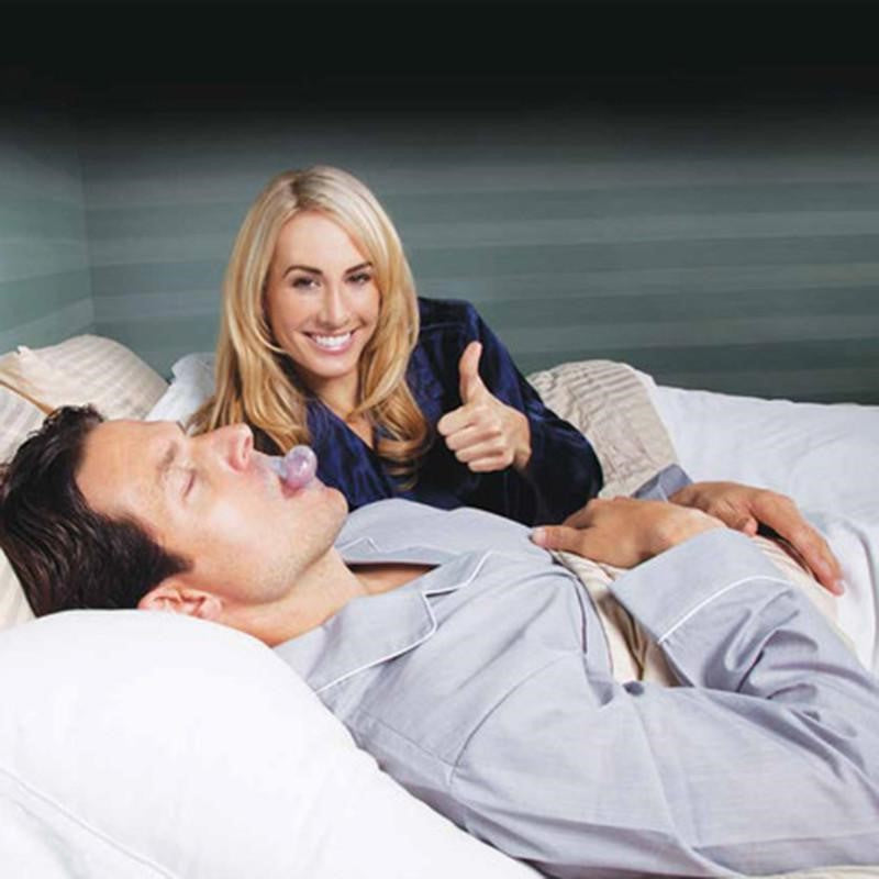 Transparent tongue stabilizing mouthpiece on sleeping person’s mouth, shown in use