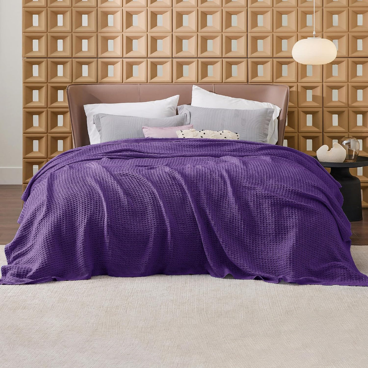 Cotton waffle-weave cooling blanket in purple, spread across a bed