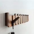 Fold-out wooden wall hook rack with a hanging umbrella-like stand