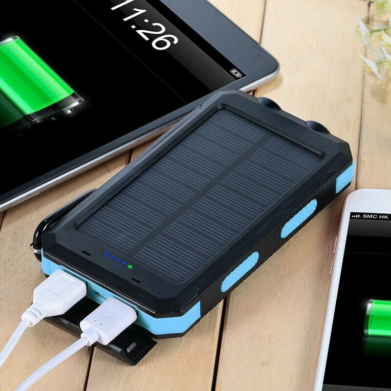 Solar waterproof power bank connected to phone via USB cables, showing blue charge lights