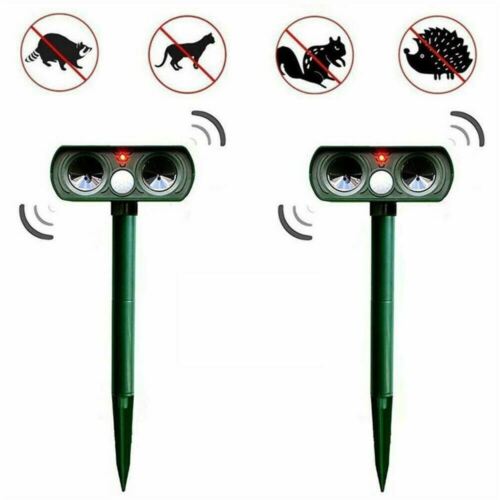 Green solar animal repeller stakes with sensor heads and motion wave icons