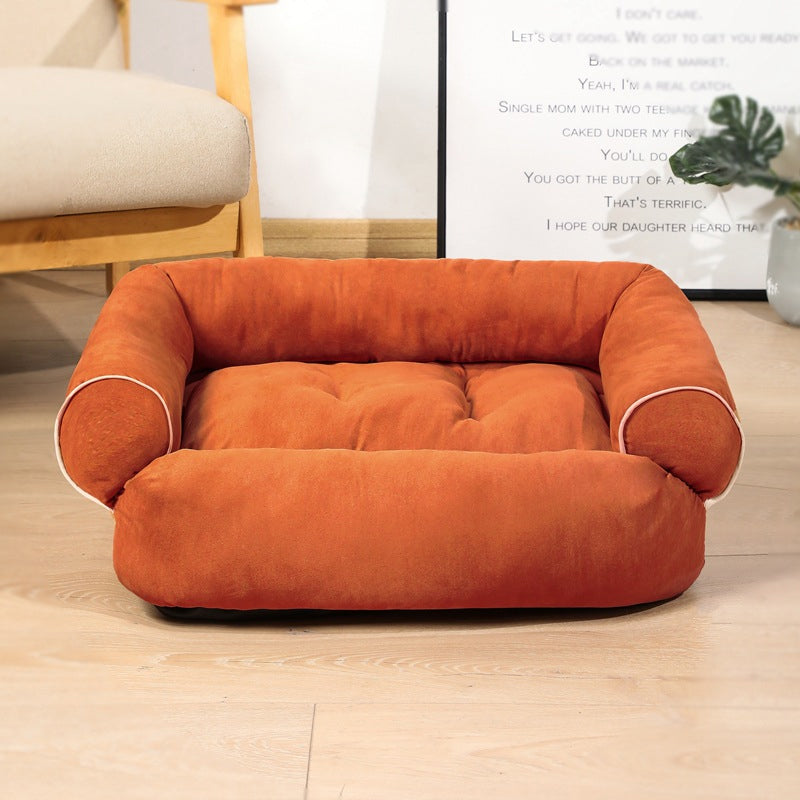 Orange egg-crate memory foam dog bed with rounded bolsters and thick padded cushion