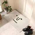 Light gray speckled doormat with simple black sad face lines and dot eyes