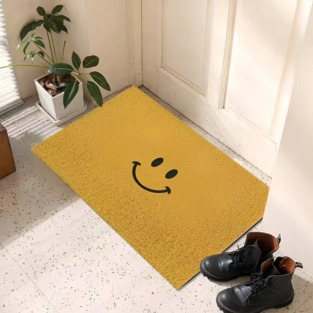 Yellow entrance doormat with black smiley face and dot eyes