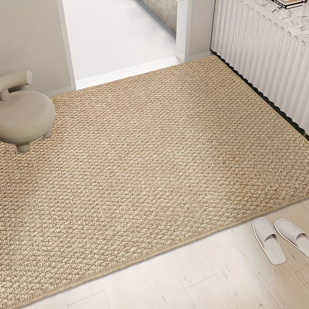 Beige textured indoor floor mat in entryway with non-slip surface under door