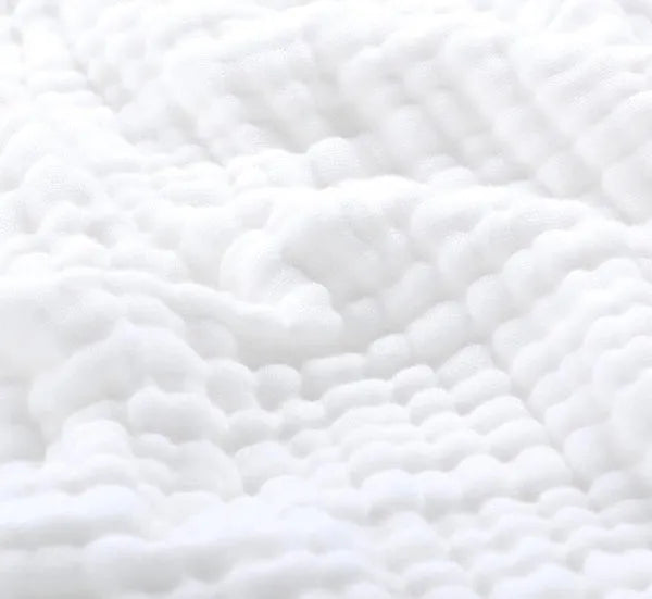 Cotton muslin throw blanket in white with bumpy crinkle weave texture