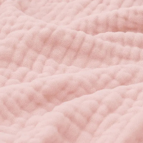 Cotton muslin throw blanket in pink with soft crinkle texture and gathered ridges