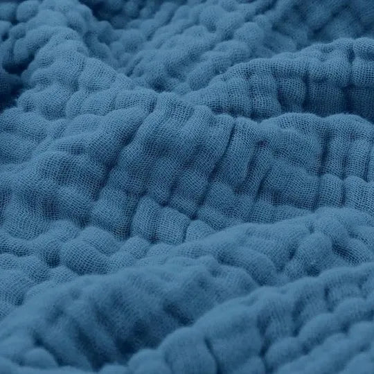 Cotton muslin throw blanket in blue with soft crinkle texture and raised ridges