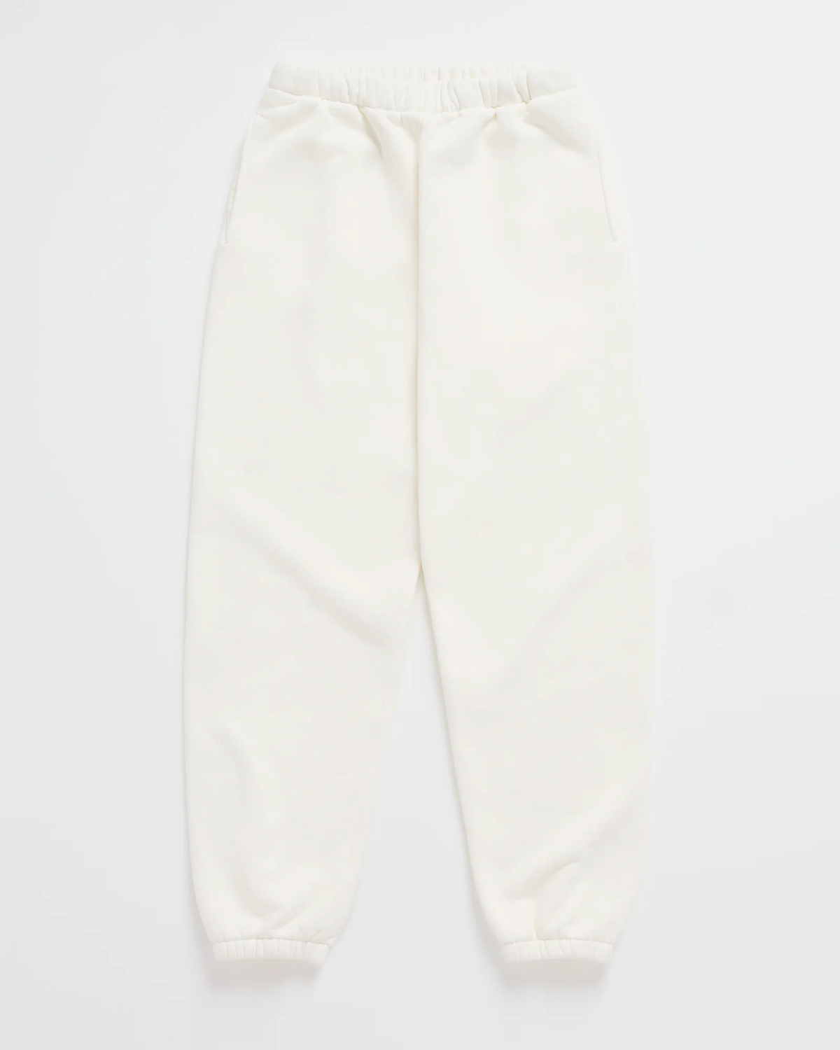 White sweatpants with elastic waistband and tapered cuffs.