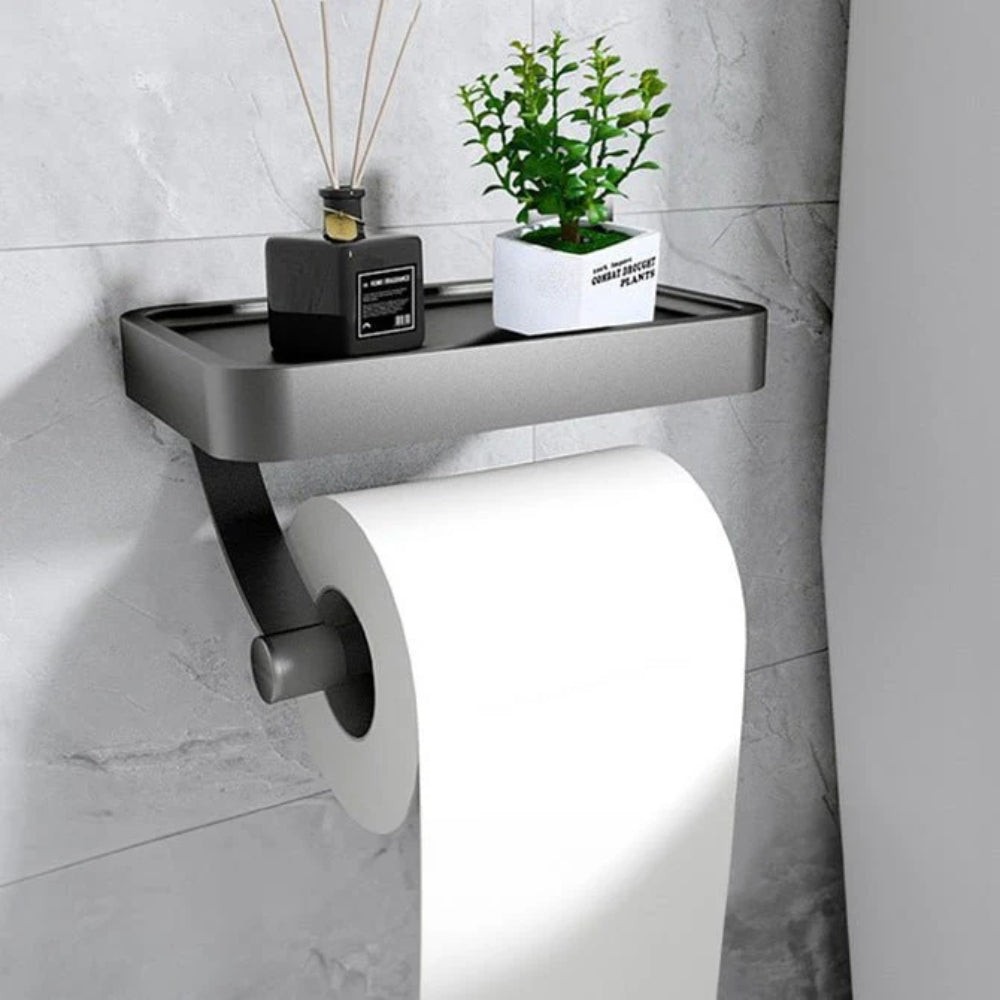 Black aluminum toilet paper holder shelf with top ledge and toilet roll on holder