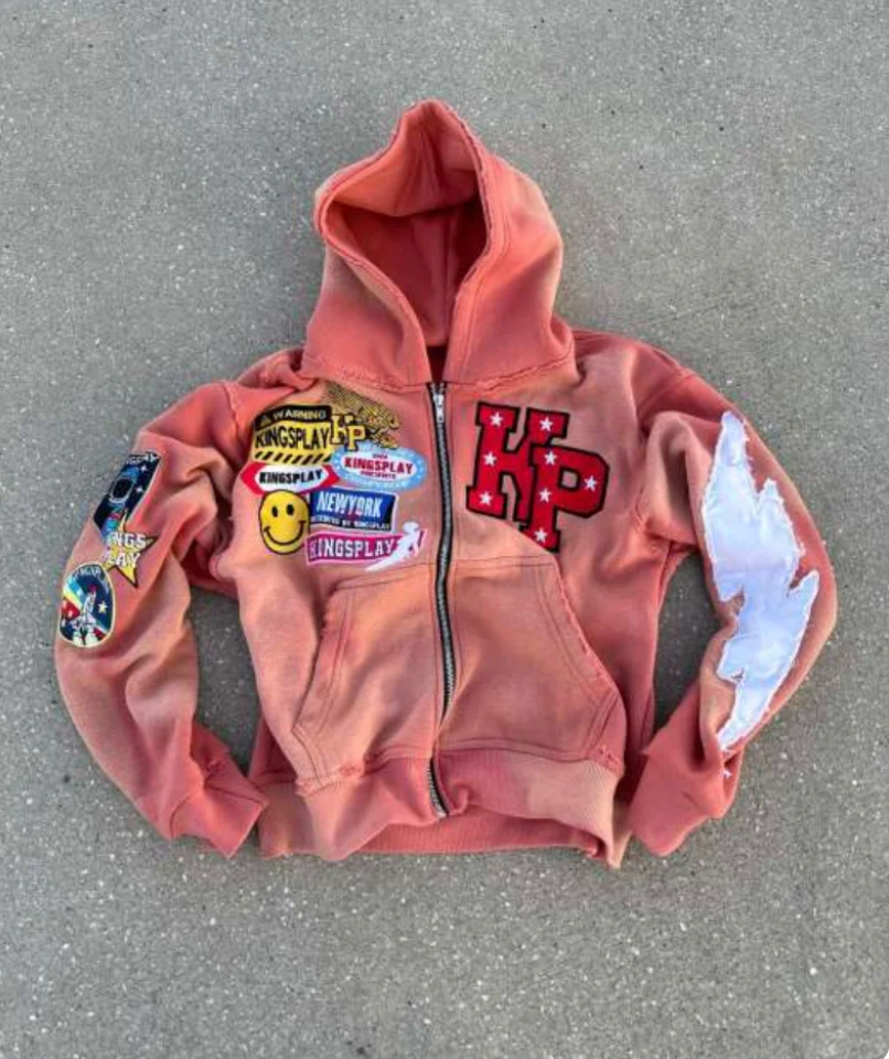 Pink zip-up hoodie jacket with hood, front pocket, and printed graphic logos