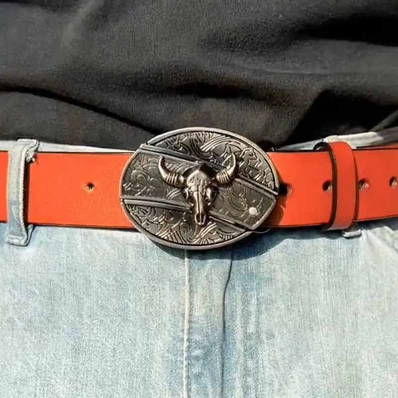 Western belt buckle with bull skull oval medallion on bright orange belt