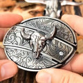 Western belt buckle with silver-toned bull skull engraving in an oval frame