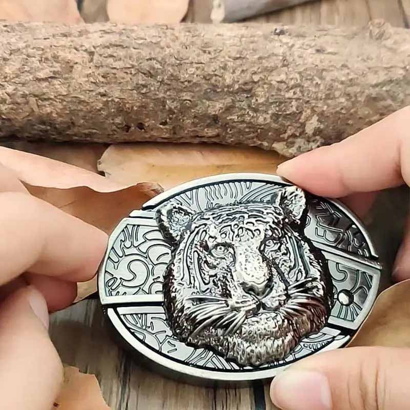 Western oval belt buckle with engraved lion head relief and ornate border, silver-tone metal