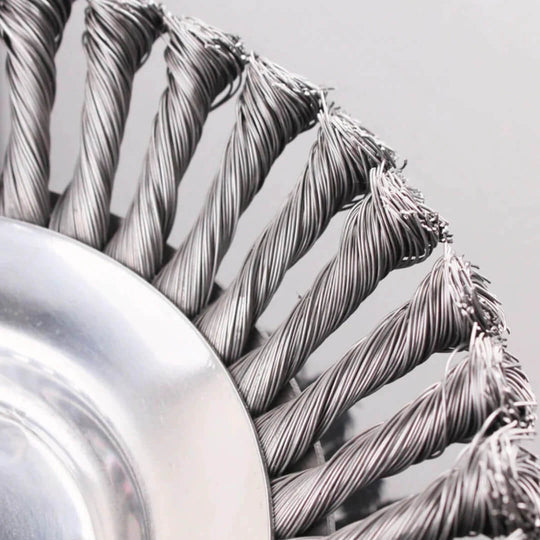 Wire brush trimmer head bristles on circular metal base, close-up