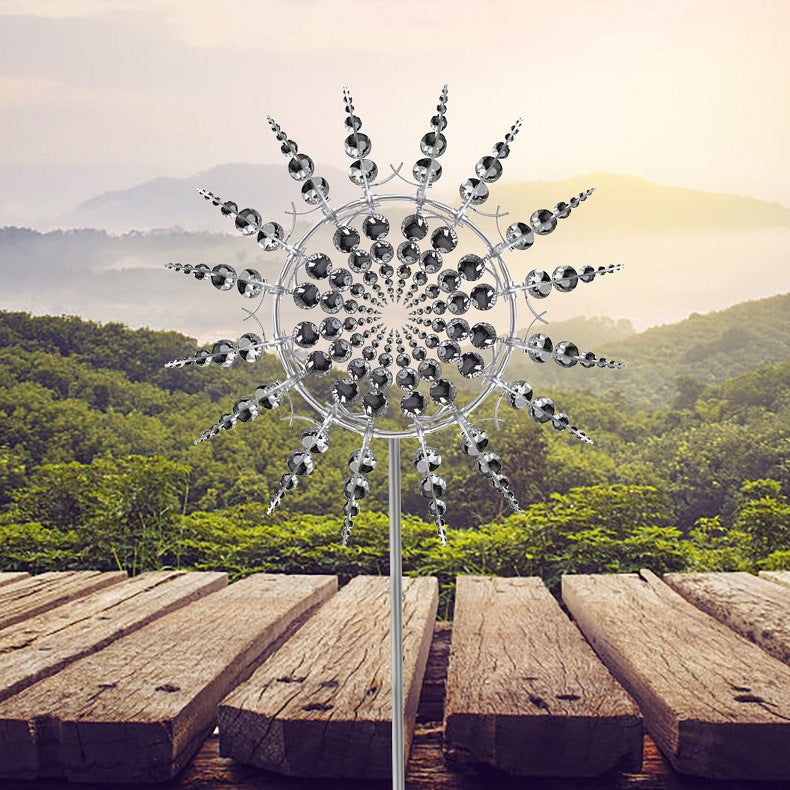 Metal garden wind spinner with radiating round discs and rods, mounted on a tall pole.
