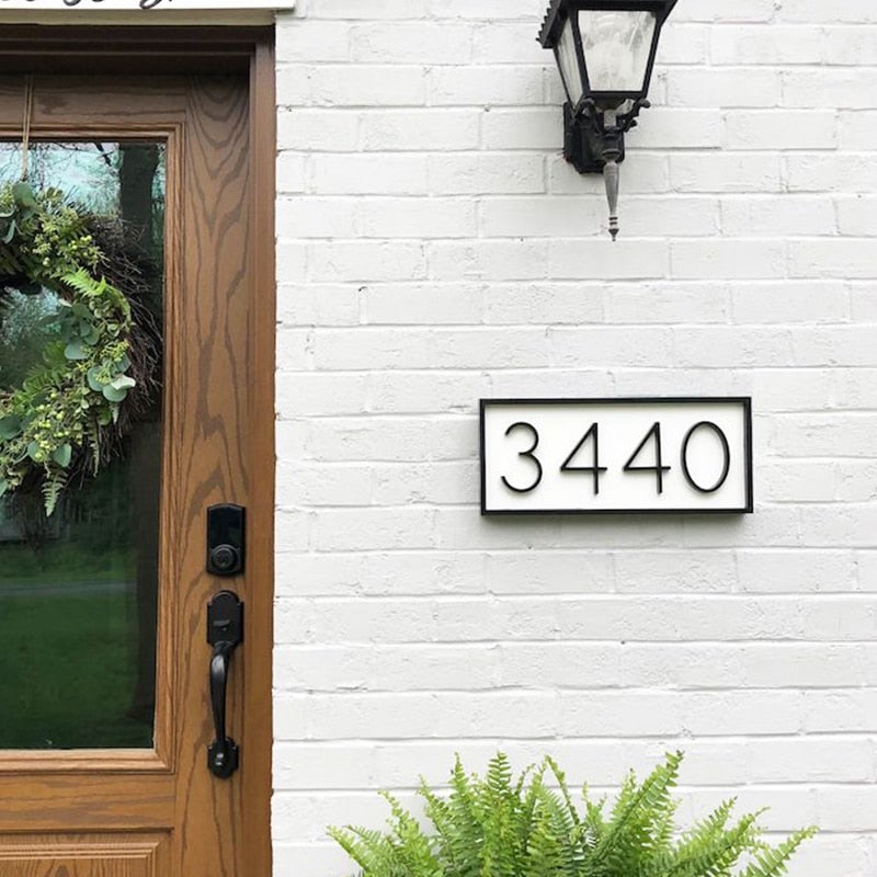 Floating metal house number 3440 with black frame
